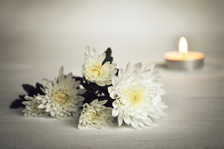 White flower and candle - Funeral Service in Holtze NT