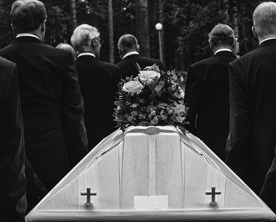 Men in Black suits carrying a casket for a Funeral