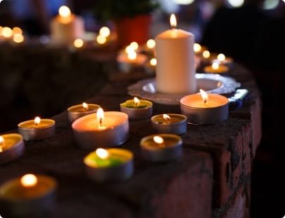 Multiple candles lit for funeral services in Darwin